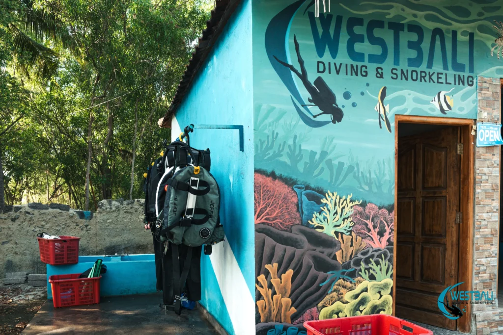 Dive equipment hangs to dry outside West Bali Diving & Snorkeling dive center in Sumberkima.