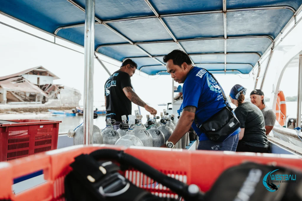 Dive pros analyze tanks and prepare equipment for scuba diving Menjangan Island with West Bali Diving & Snorkeling PADI dive center in Sumberkima.