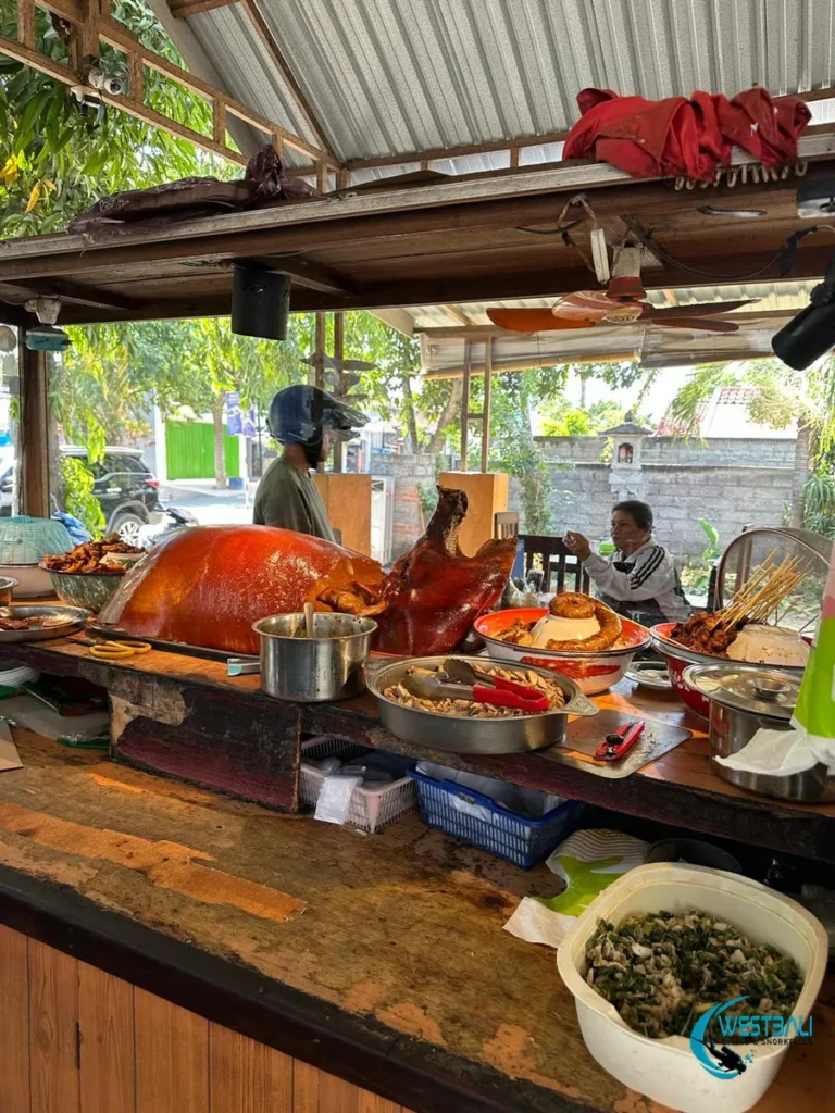 A pig's head and crispy skin on display with babi guling at Babi Guling Pak Dodot Sumberkima.