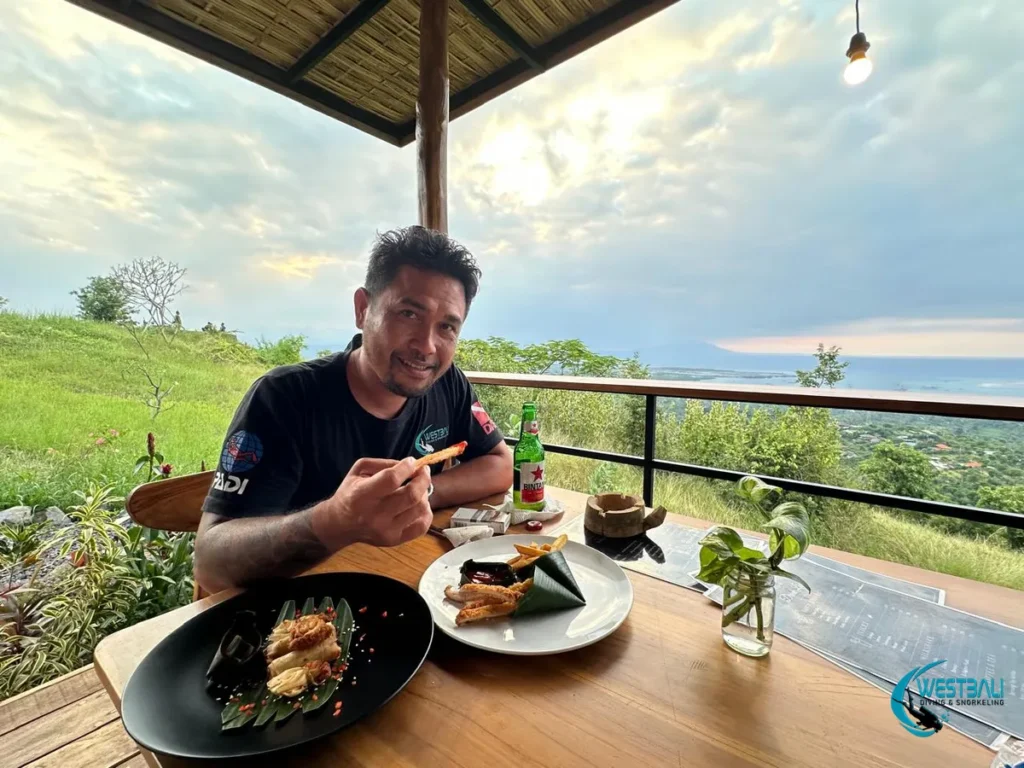 Komang of West Bali Diving & Snorkeling enjoys appetizers and a Bintang at D'lingker Cafe.