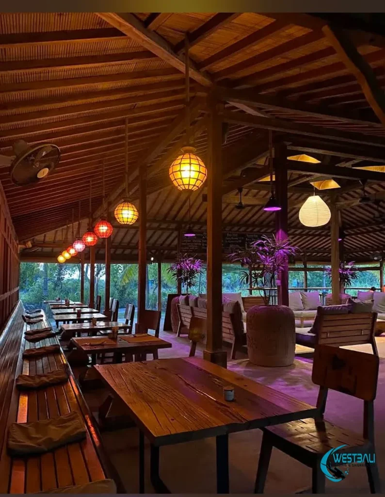 Mangroove Bay Restaurant in Sumberkima with decorative lighting during dusk.