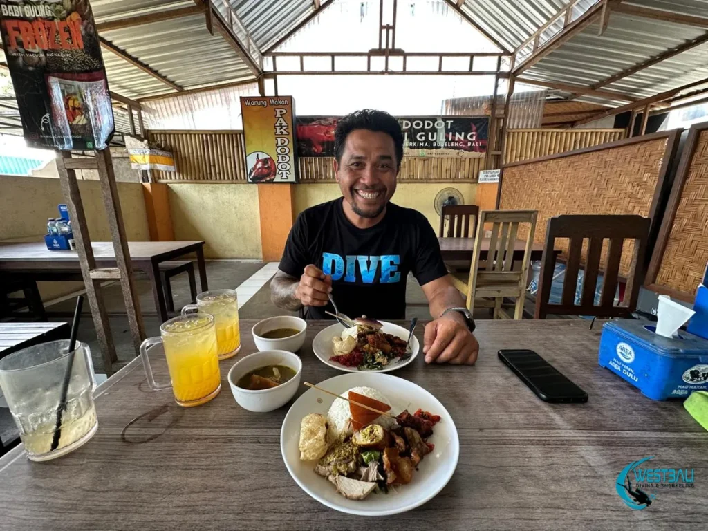 Komang is excited to dig into a plate of food at Babi Guling Pak Dodot Sumberkima.
