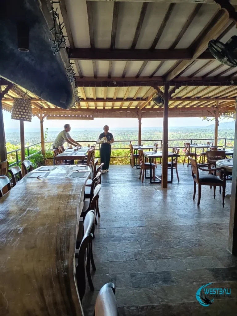 Staff prepare tables at Suma Restaurant, one of the best restaurants in Sumberkima.