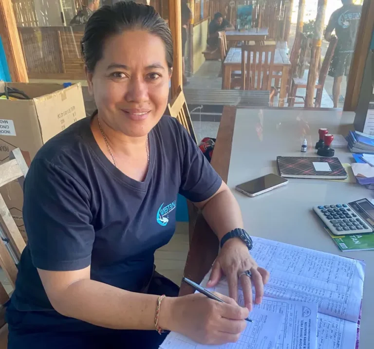 Ari works on the books in the office at West Bali Diving & Snorkeling.